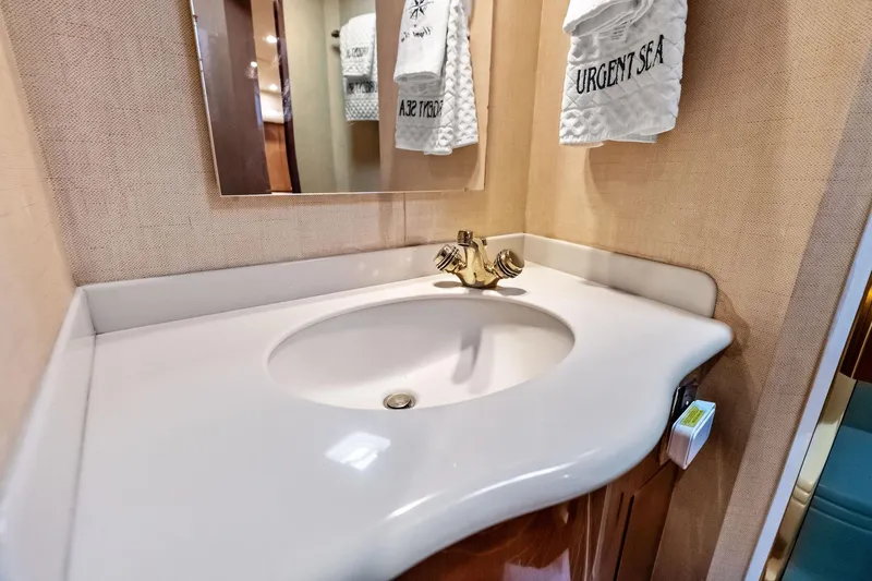 Urgent Sea Yacht Photos Pics Luxurious bathroom sink in 2003 Viking 45 Open yacht, featuring elegant fixtures and decor.