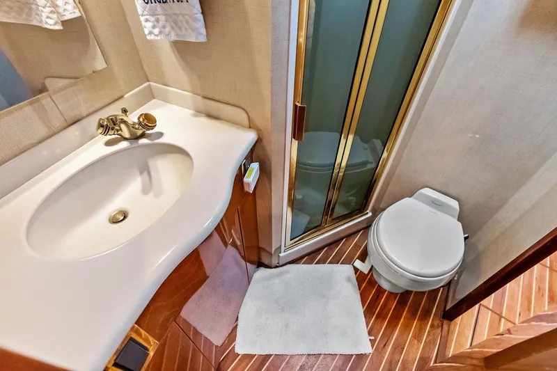 Urgent Sea Yacht Photos Pics Bathroom interior of 2003 Viking 45 Open yacht with sink, toilet, and shower.