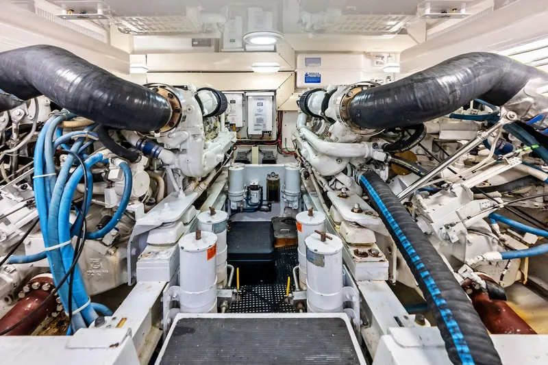 Urgent Sea Yacht Photos Pics Engine room of a 2003 Viking 45 Open yacht, showcasing complex machinery and piping.