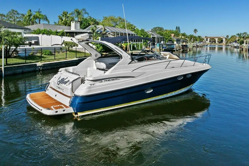 Yaeli Yacht Photos Pics 2005 Regal Commodore 3560 yacht cruising in a scenic canal setting.