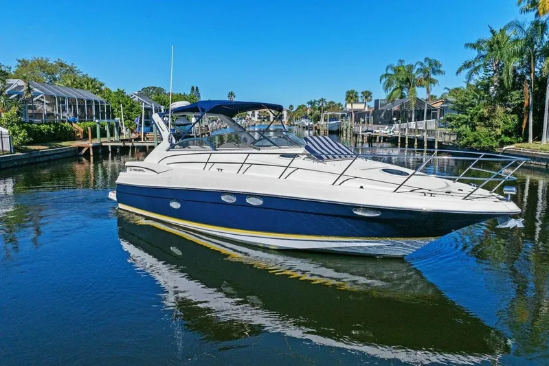 Yaeli Yacht Photos Pics 2005 Regal Commodore 3560 yacht cruising in a sunny, tropical canal setting.