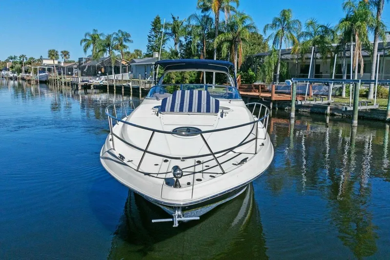 Yaeli Yacht Photos Pics 2005 Regal Commodore 3560 yacht docked in a scenic waterfront setting with palm trees.