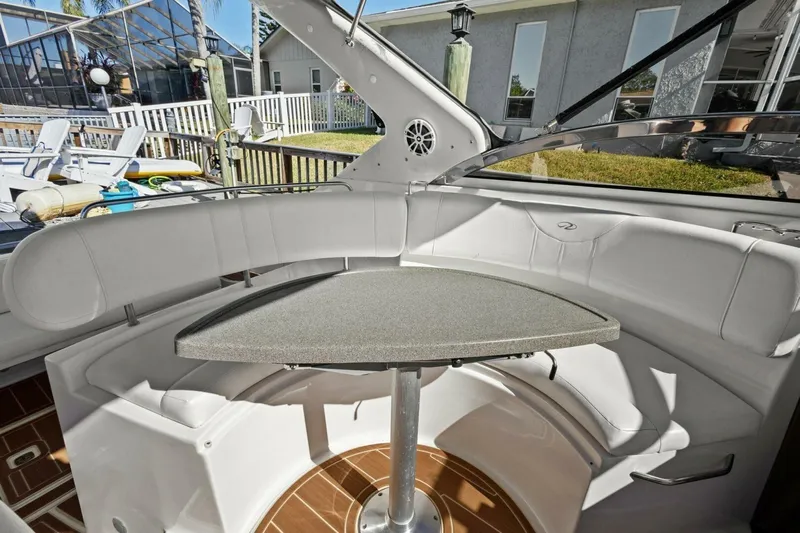 Yaeli Yacht Photos Pics 2005 Regal Commodore 3560 boat interior with white seating and a central table.