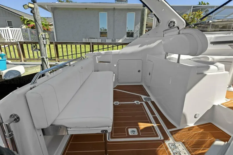 Yaeli Yacht Photos Pics 2005 Regal Commodore 3560 boat interior with white seating and wooden flooring.
