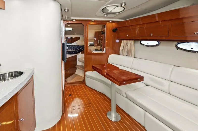 Yaeli Yacht Photos Pics Luxurious interior of 2005 Regal Commodore 3560 yacht with elegant wood and leather finishes.