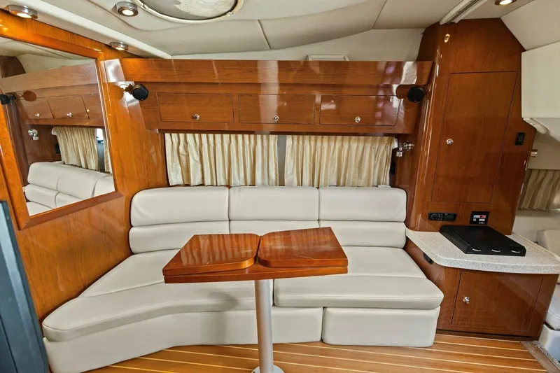 Yaeli Yacht Photos Pics Interior of 2005 Regal Commodore 3560 yacht with elegant seating and wooden cabinetry.