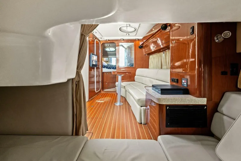 Yaeli Yacht Photos Pics Luxurious interior of 2005 Regal Commodore 3560 yacht with wood accents and plush seating.