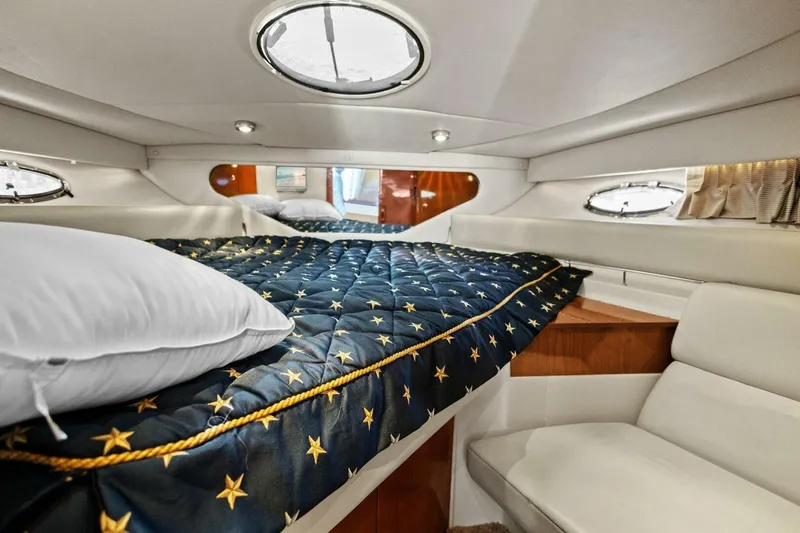 Yaeli Yacht Photos Pics Luxurious cabin interior of 2005 Regal Commodore 3560 yacht with star-patterned bedding.