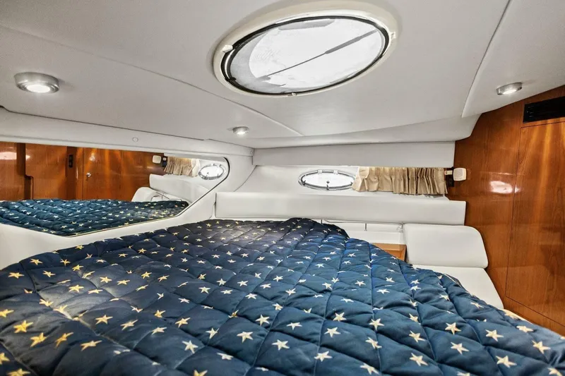 Yaeli Yacht Photos Pics Luxurious cabin interior of 2005 Regal Commodore 3560 yacht with star-patterned bedding.