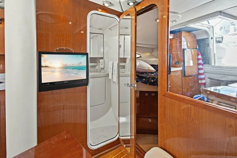 Yaeli Yacht Photos Pics Luxurious interior of 2005 Regal Commodore 3560 yacht with wood finishes and modern amenities.