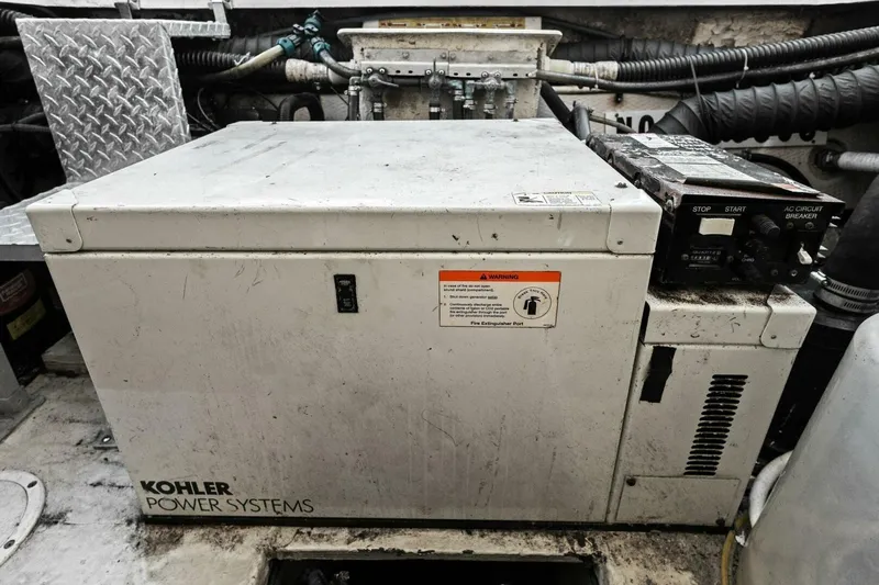 Yaeli Yacht Photos Pics Kohler power system in 2005 Regal Commodore 3560 engine room, showing control panel and warning label.