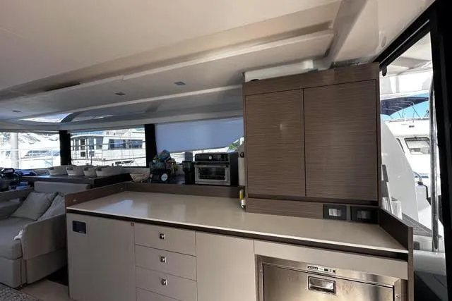 Wander Twins Yacht Photos Pics Modern kitchen interior on 2023 Leopard 46 PC yacht, featuring sleek cabinetry and appliances.