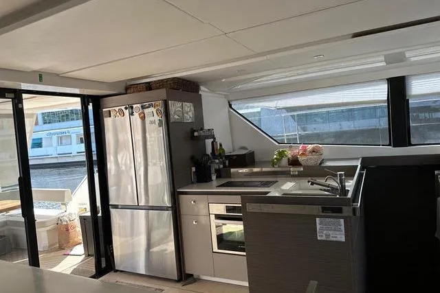 Wander Twins Yacht Photos Pics Modern kitchen interior of 2023 Leopard 46 PC yacht with stainless steel appliances.