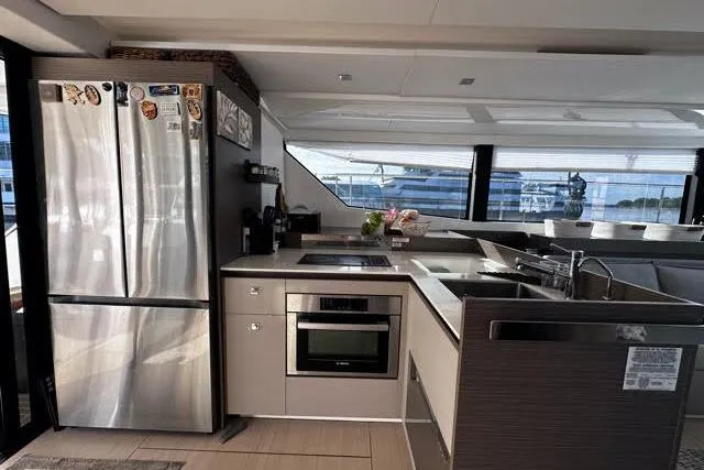 Wander Twins Yacht Photos Pics Modern kitchen interior on 2023 Leopard 46 PC yacht with stainless steel appliances.
