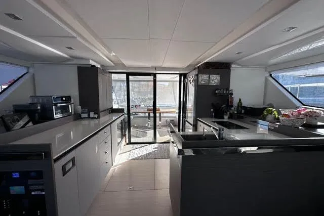 Wander Twins Yacht Photos Pics Luxurious interior of 2023 Leopard 46 PC yacht with modern kitchen design.