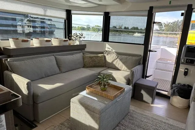Wander Twins Yacht Photos Pics Luxurious interior of 2023 Leopard 46 PC yacht with modern seating and panoramic windows.