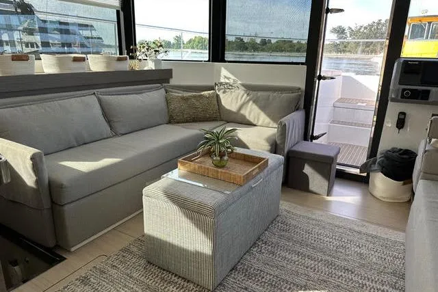 Wander Twins Yacht Photos Pics Modern interior of 2023 Leopard 46 PC yacht with cozy seating and stylish decor.