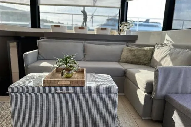 Wander Twins Yacht Photos Pics Luxurious interior of 2023 Leopard 46 PC yacht with modern gray seating and decor.