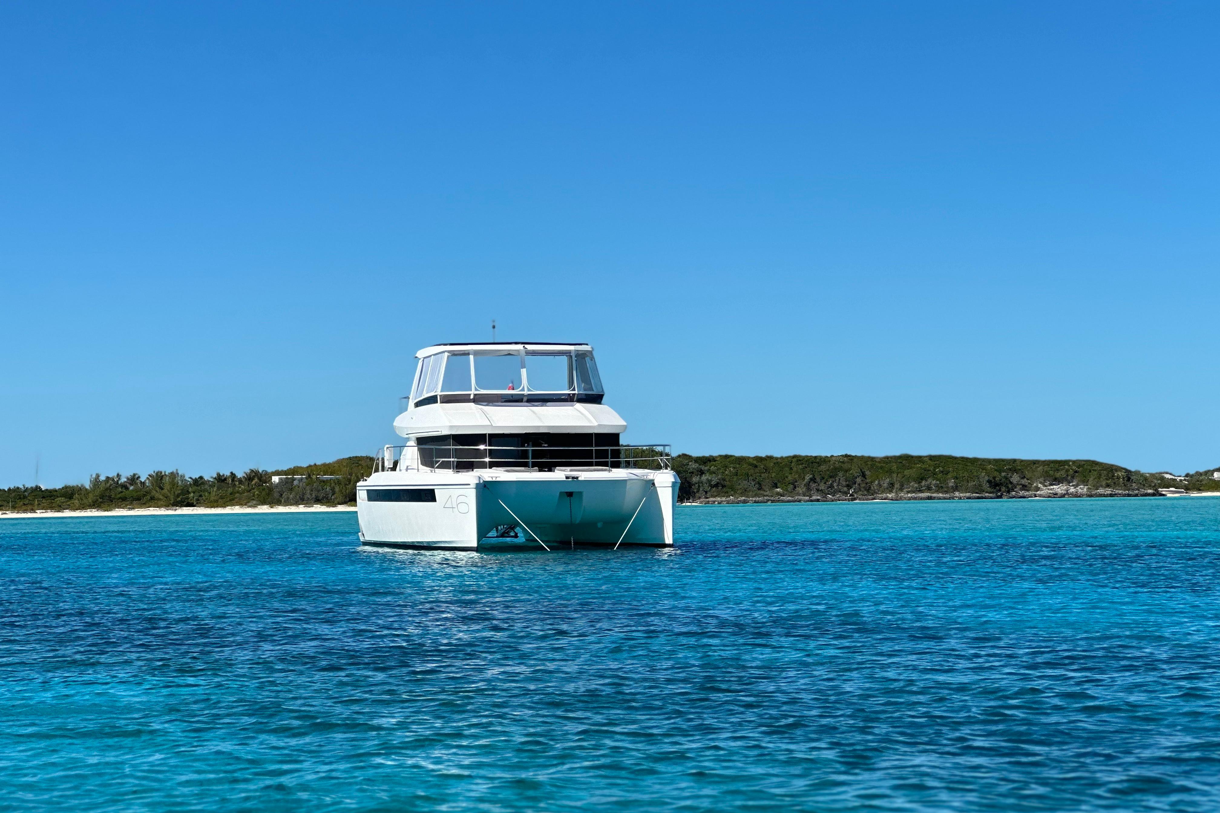 2023 Leopard 46 PC yacht on clear blue water under a bright sky.