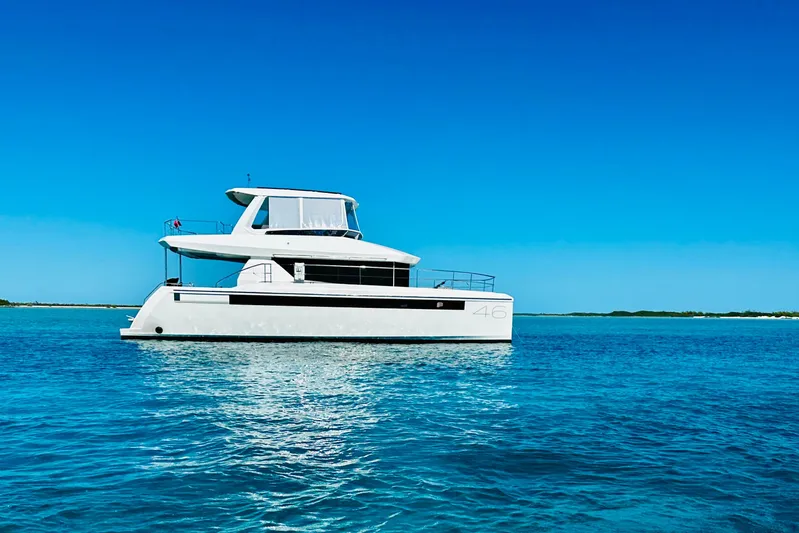 Wander Twins Yacht Photos Pics 2023 Leopard 46 PC yacht on clear blue water under a bright sky.