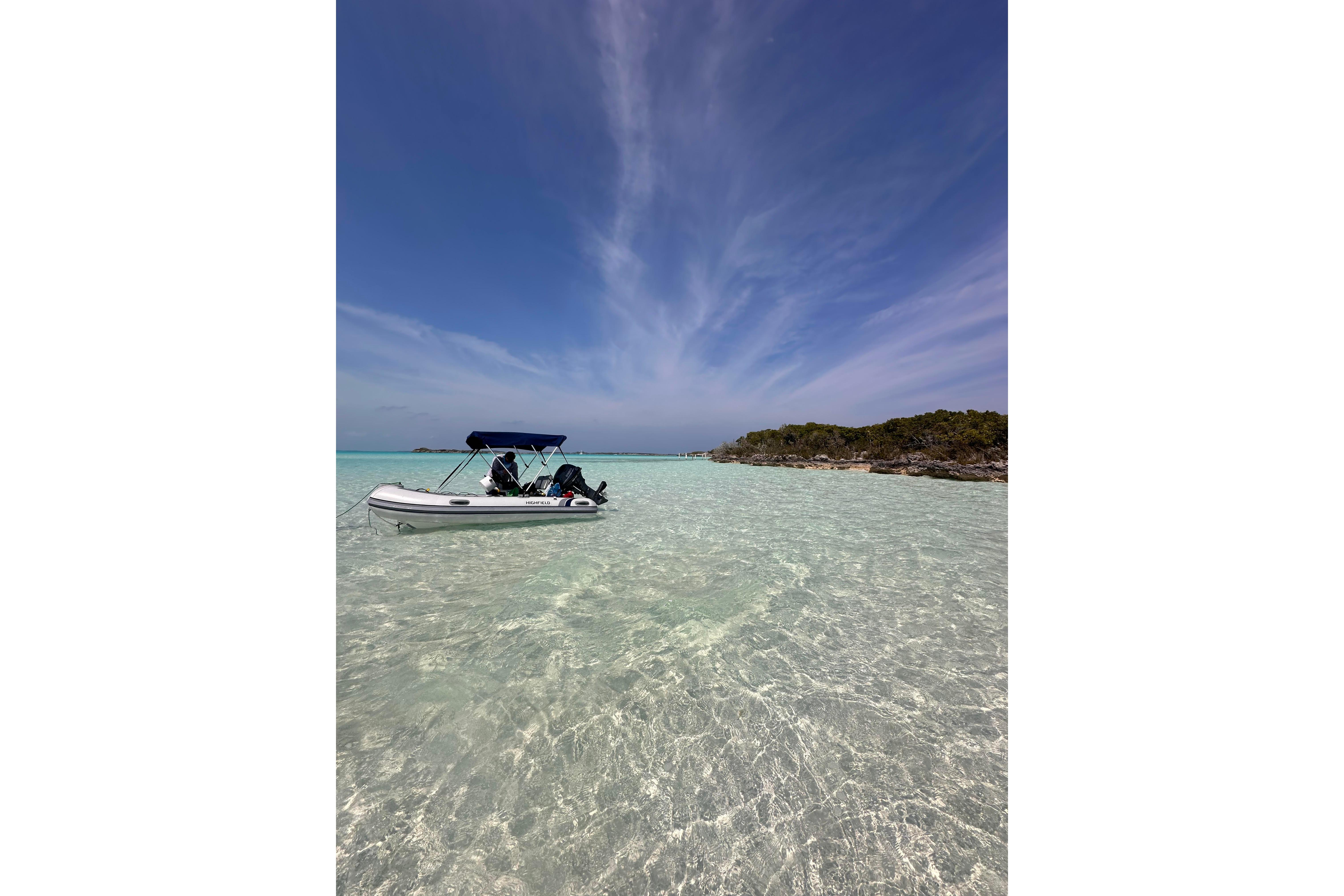 A 2023 Leopard 46 PC boat on clear turquoise water under a blue sky.