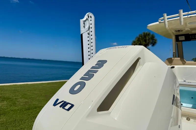  Yacht Photos Pics 2025 Scout 261 XSS boat with Mercury 350 V10 engine by the water.