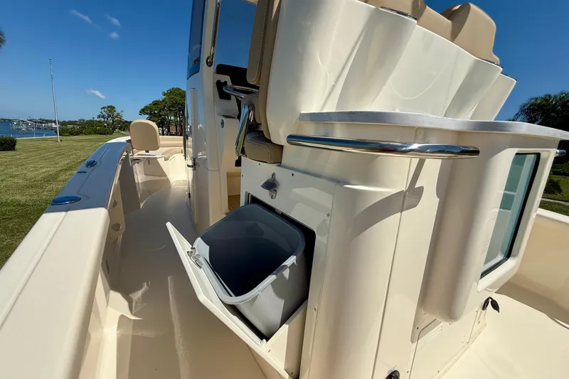  Yacht Photos Pics 2025 Scout 261 XSS boat interior with open storage compartment, sleek design, and sunny outdoor setting.