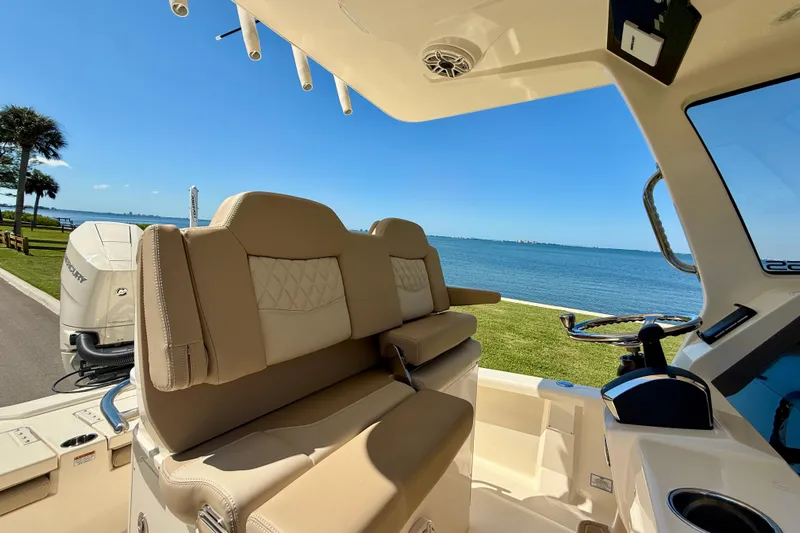  Yacht Photos Pics 2025 Scout 261 XSS boat interior with luxurious seating and scenic waterfront view.