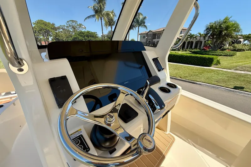  Yacht Photos Pics 2025 Scout 261 XSS boat helm with steering wheel and control panel.