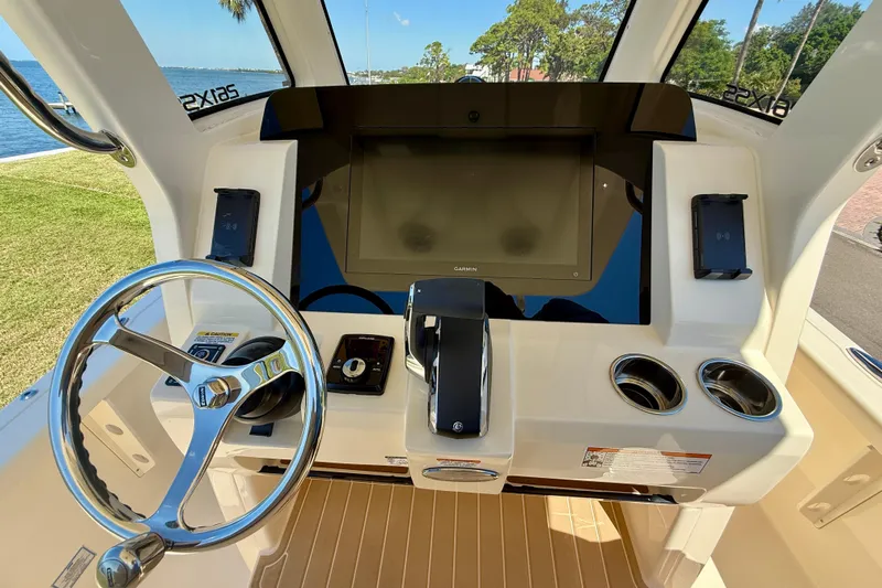  Yacht Photos Pics 2025 Scout 261 XSS boat helm with steering wheel, touchscreen, and controls.