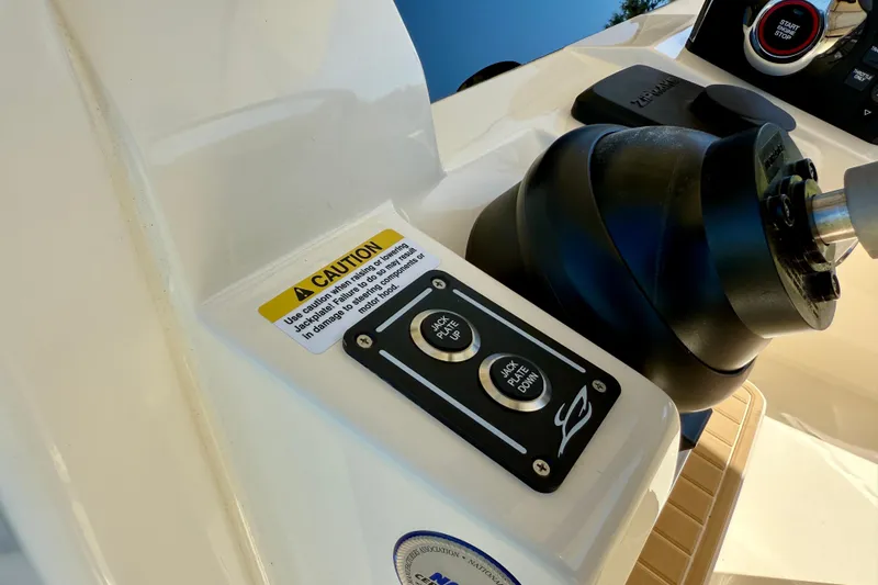  Yacht Photos Pics Control panel of 2025 Scout 261 XSS boat with caution label and jack plate buttons.