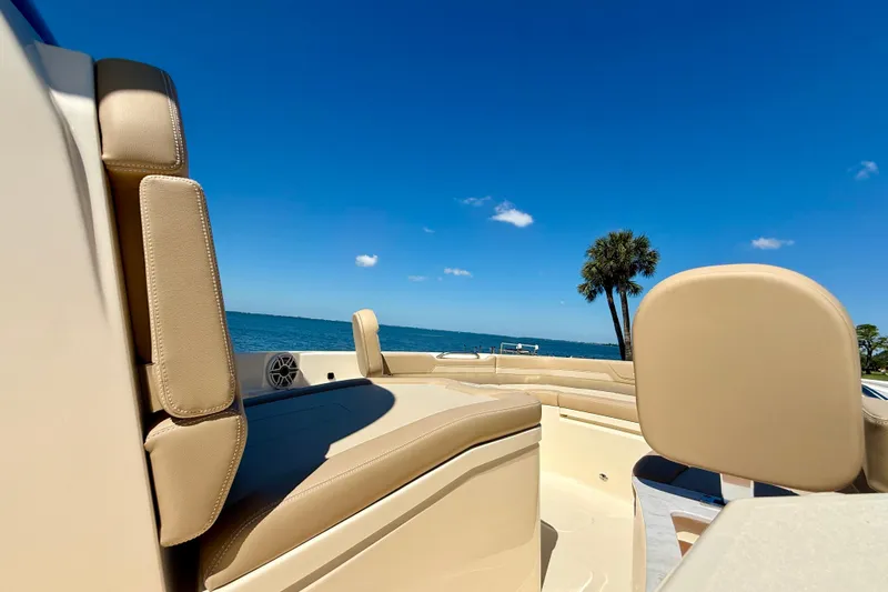  Yacht Photos Pics 2025 Scout 261 XSS boat interior with beige seating, ocean view, and clear blue sky.