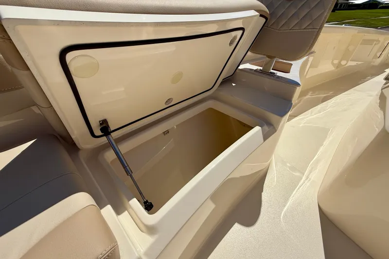  Yacht Photos Pics 2025 Scout 261 XSS boat storage compartment with open lid, showcasing spacious interior.