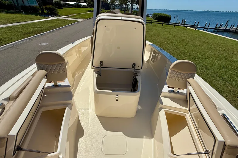  Yacht Photos Pics 2025 Scout 261 XSS boat interior with open storage compartments, dockside view.