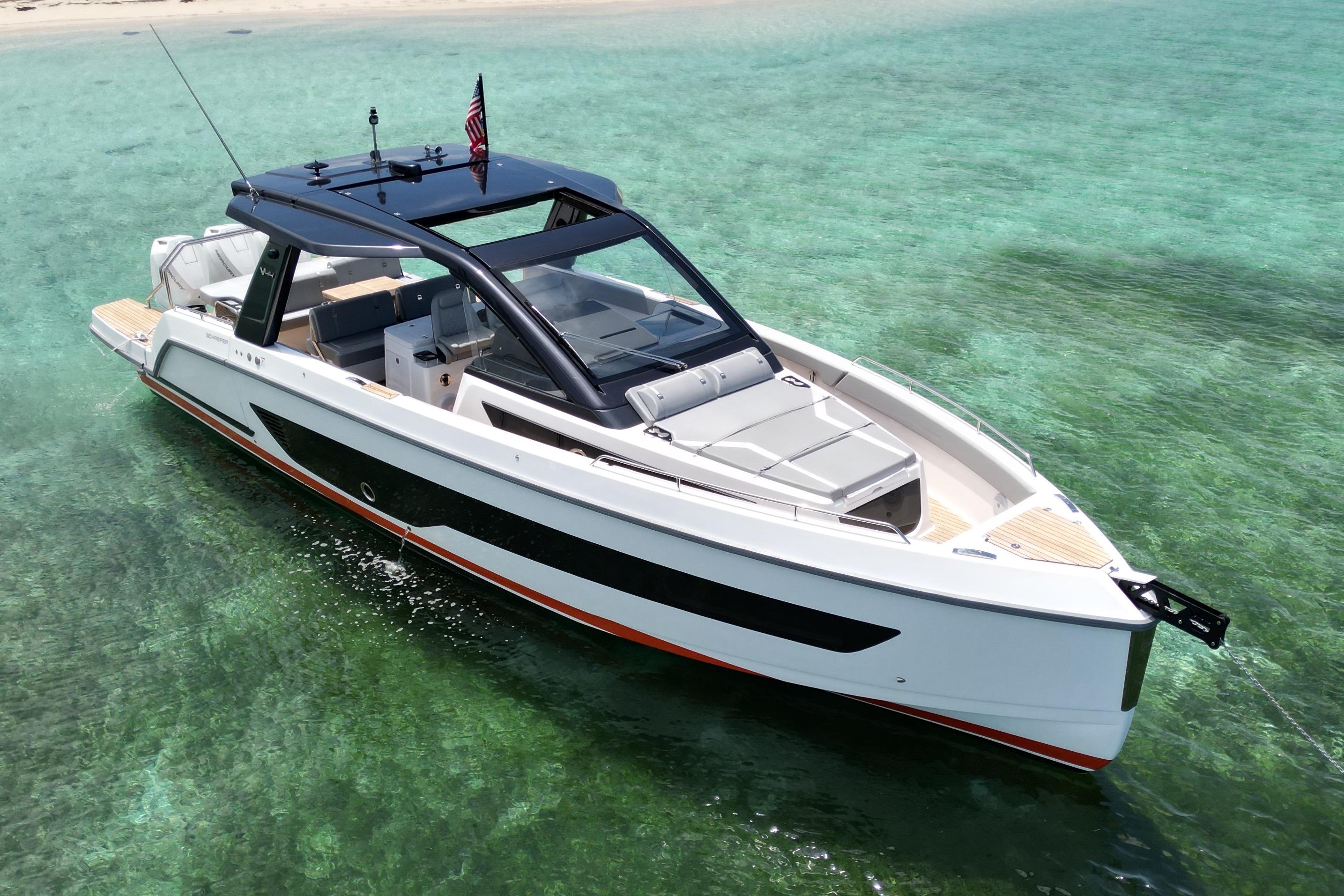 Schaefer Yachts V44 2026 model cruising in clear turquoise waters near a sandy beach.