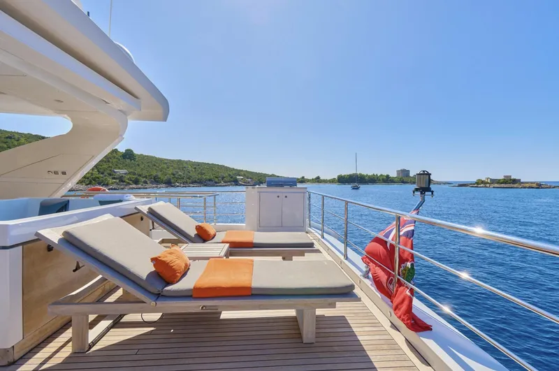 Silvia Yacht Photos Pics Luxurious Azimut Grande 30 Metri yacht deck with sun loungers, overlooking serene blue waters.