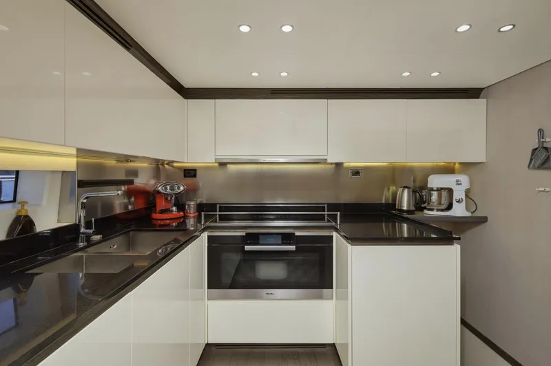 Silvia Yacht Photos Pics Modern kitchen interior on 2018 Azimut Grande 30 Metri yacht, featuring sleek cabinetry and appliances.