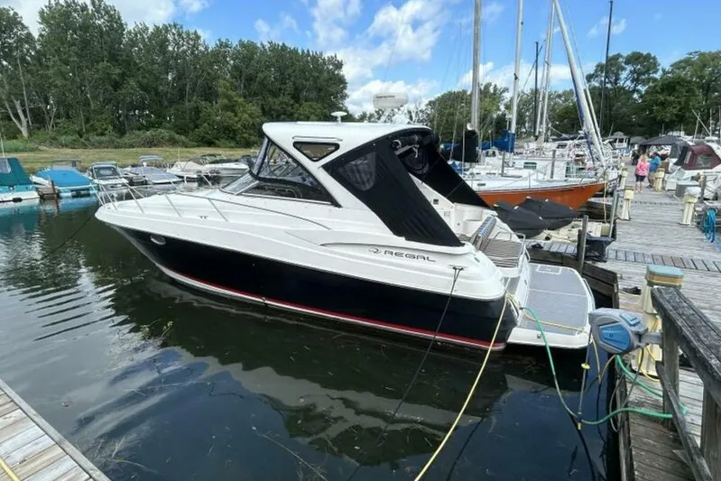  Yacht Photos Pics 2007 Regal 3760 Commodore yacht docked at a marina, surrounded by other boats.