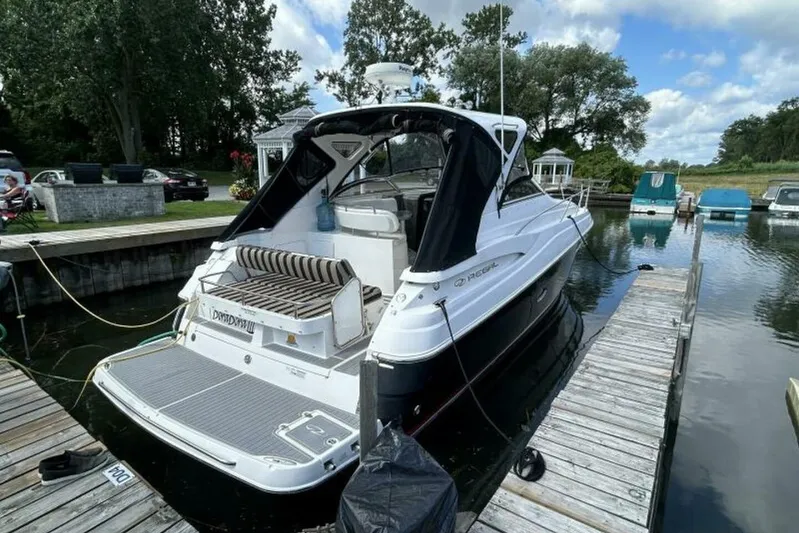  Yacht Photos Pics 2007 Regal 3760 Commodore yacht docked at a marina, surrounded by trees and water.