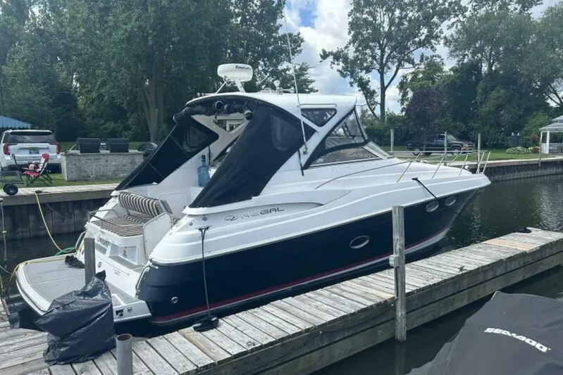  Yacht Photos Pics 2007 Regal 3760 Commodore yacht docked at a marina, surrounded by trees and vehicles.