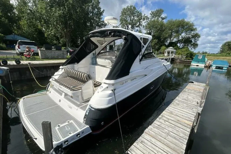  Yacht Photos Pics 2007 Regal 3760 Commodore yacht docked at a marina with lush greenery.