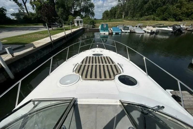  Yacht Photos Pics 2007 Regal 3760 Commodore yacht docked at a marina, surrounded by trees and other boats.