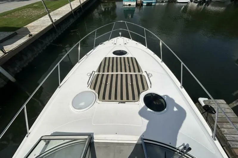  Yacht Photos Pics 2007 Regal 3760 Commodore yacht deck view at marina, featuring striped sun pads.