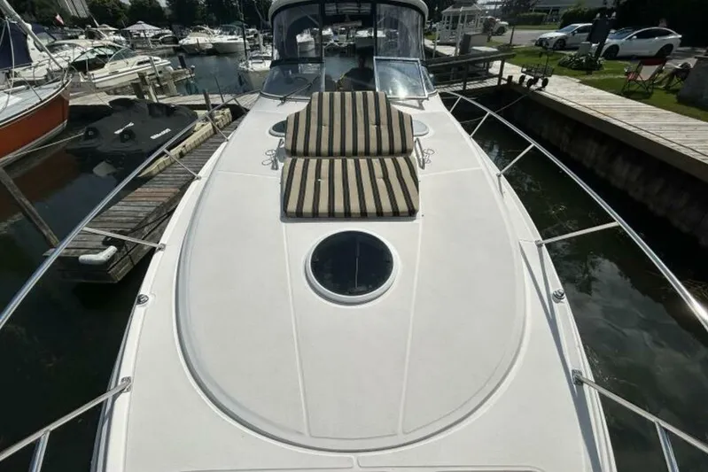  Yacht Photos Pics 2007 Regal 3760 Commodore yacht with striped sun pads docked at marina.