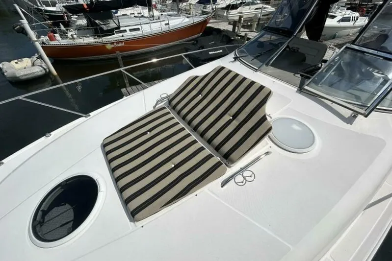  Yacht Photos Pics 2007 Regal 3760 Commodore yacht with striped sun pads on deck, docked at marina.