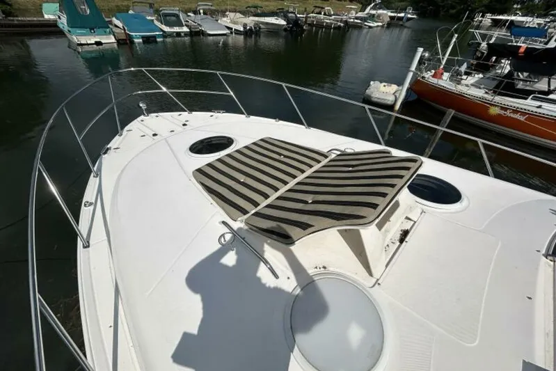  Yacht Photos Pics 2007 Regal 3760 Commodore yacht deck with striped sun pads, docked in a marina.