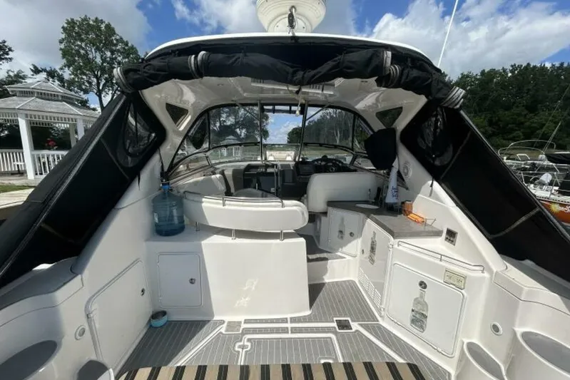  Yacht Photos Pics 2007 Regal 3760 Commodore yacht interior with seating and helm, docked under blue sky.