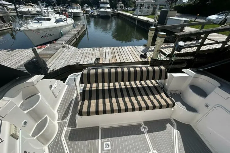  Yacht Photos Pics 2007 Regal 3760 Commodore boat with striped seating at a marina dock.