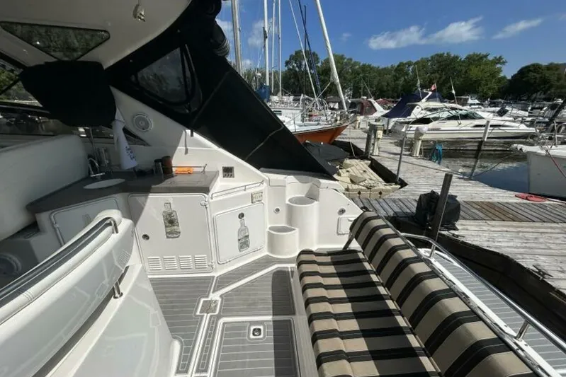  Yacht Photos Pics 2007 Regal 3760 Commodore yacht interior with striped seating at marina dock.