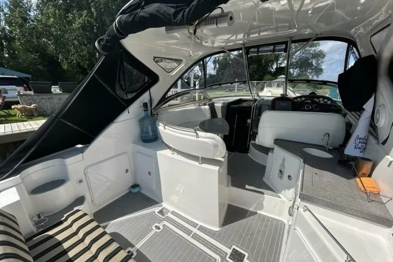  Yacht Photos Pics 2007 Regal 3760 Commodore boat interior with seating and helm, docked outdoors.